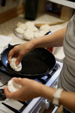 Senior cook prepares tasty pancake at homeの写真素材