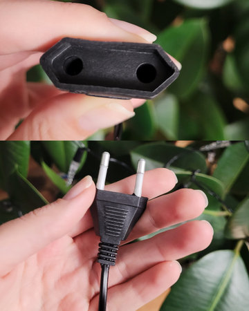 Black Electrical Plug in Hand Close-Up