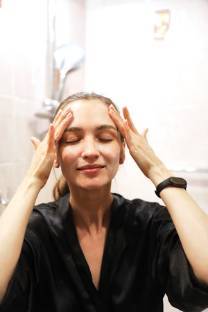 Woman Applying Face Cream, Bathroom Routineの写真素材