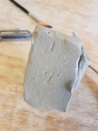 Sculpting Moment: Gray Clay and Artisan's Hand
