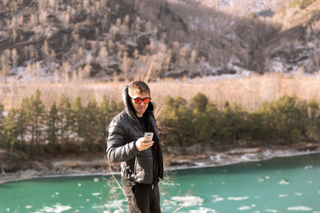 Selfie of man by beautiful turquoise mountain lakeの写真素材