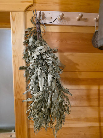 Traditional Banya Venik with Dried Leaves on Wooden Wallの写真素材