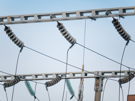 Close up of electric power line insulators at high voltage substation. Electricity transmission...