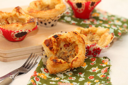 

Open puff pastry pies with the stuffing from chicken, carrots, onions and cheese の写真素材