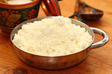 house rural cottage cheese in a metal bowlの写真素材