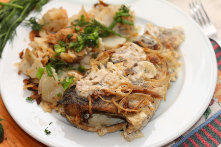 fried crucians in sour cream with a potato garnish on ruralの写真素材