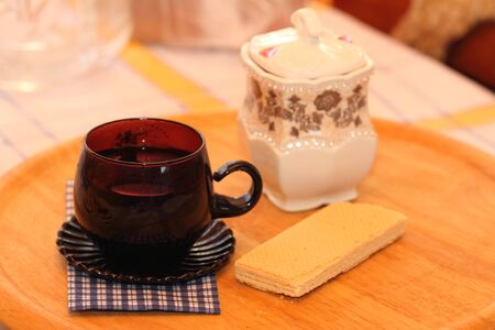 cup with drink, a wafer with a napkin on a clothの写真素材