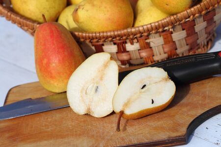 crop of pears in a wattled basket on a white background from old boardsの写真素材