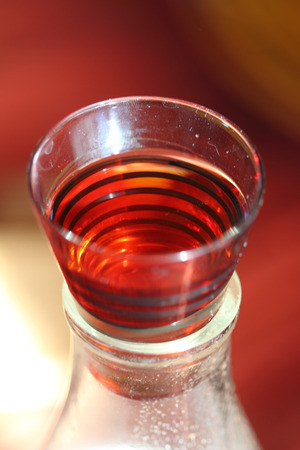 old kind house liqueur from a guelder-rose in a striped glassの写真素材