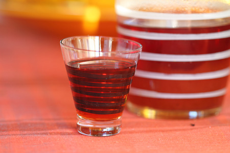 old kind house liqueur from a guelder-rose in a striped glassの写真素材