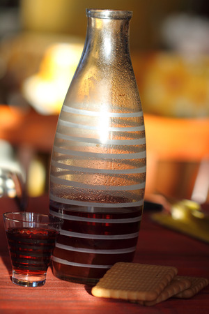 old kind house liqueur from a guelder-rose in a striped glassの写真素材
