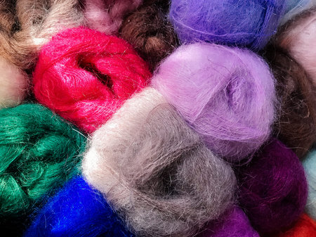 Texture of different colored balls of wool. Conceptual for hobbies and home entertainment.