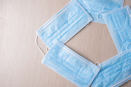 new medical masks of blue color lie on the tableの写真素材