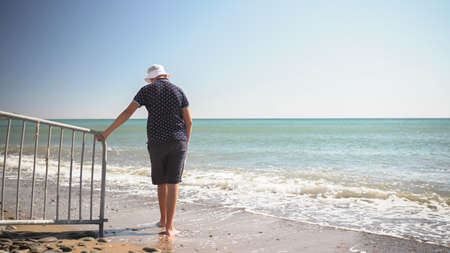 the guy is sad at the edge of the beach. he was thinking about somethingの写真素材