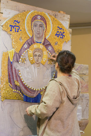 Women make of mosaic icon "Virgin with Jesus" in orthodox (byzantine) style.の写真素材