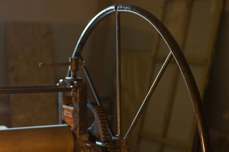 Close-up of old litographic press. Shallow DOF? fpcus on right part of wheelの写真素材