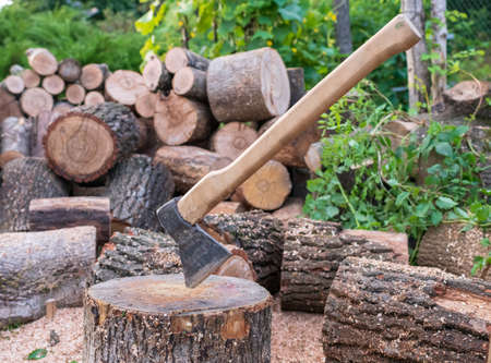 Photography on theme big steel ax with wooden handle, metal ax for hunting. Photo ax consisting of one long ax on natural nature background. Forged ax it main accessory male, heavy ax for survival.の写真素材