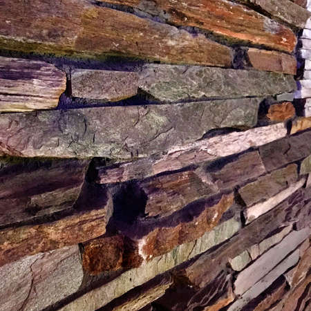 Old textured brick wall of stylish stones for home decor. Facing retro design stones to ornament house of brick dark wall. Brick fashion walls is natural vintage structured stone from organic nature.の写真素材