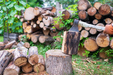 Photography on theme big steel ax with wooden handle, metal ax for hunting. Photo ax consisting of one long ax on natural nature background. Forged ax it main accessory male, heavy ax for survival.の写真素材