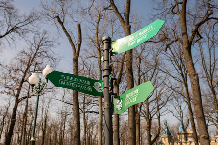 Gostomel, Ukraine - Apr. 03, 2022: Photography to theme broken high signpost in park on Ukraine war background, war photo consisting of big park signpost, war signpost in Ukraine park with many treesのeditorial素材