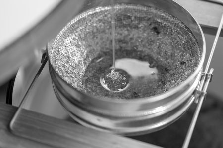 Drop of bee honey drip from hexagonal honeycombs filled with golden nectar. Honeycombs summer composition consisting of drop natural honey, drip on wax frame bee. Drop of bee honey drip in honeycombs.の写真素材