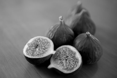 Photography to theme beautiful sweet purple fruit fig on wooden table background. Photo consisting...
