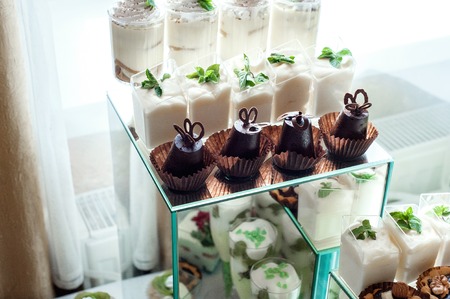 Cake, candies, marshmallows, cake, fruits and other sweets on dessert holiday table buffetの写真素材