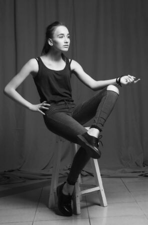 Sexy female model posing in fashion dress, black and white photo, colorless.の写真素材