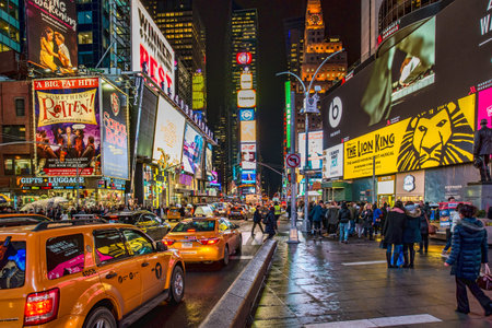 Night scene of Times Square in Manhattan (New York City) with all the lit up billboards and...