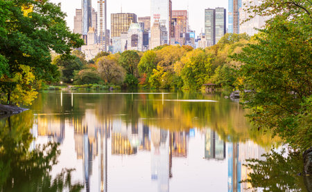 Pond in the central park in NYC. Central Park and Manhattan Skyline. Midtown Manhattan skyline view...