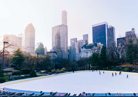 Winter day scenery with New York city architecture skyline and ice rink in Central Park in New York City.のeditorial素材