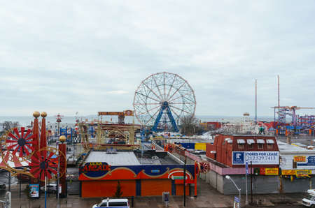 A construction crew works outside near Luna Park in Coney Island amusement parkのeditorial素材
