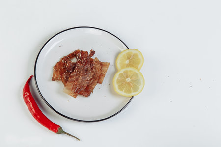 mountain of cured meat with spices on a table with red pepper