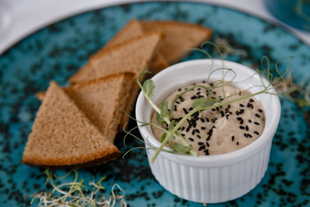 Bowl of tomato soup with deli meat on black background directly aboveの写真素材