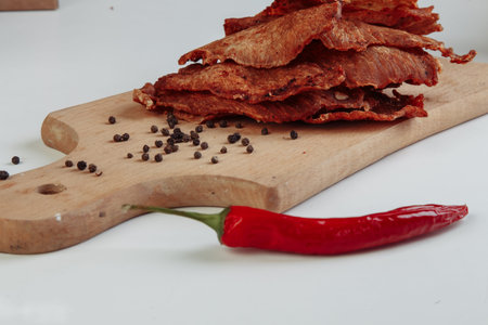 Some craft cardboard boxes with dehydrated dog treats, the highest one is opened, full of dry meat crunchy tastes from beef and chicken. Homemade pet food, healthy and natural. Copy space. High quality photoの写真素材