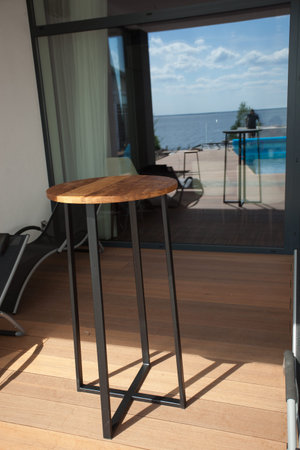 Wooden chairs and tables on the street in the tropics among the foliage. Exterior of cafe or lounge zone. High quality photoの写真素材