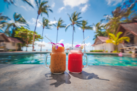 Sweet dessert fruit. Exotic tropical beach background. Juicy natural fruit. Healthy nutrition. Sea and pool background. Summer vacation.の写真素材