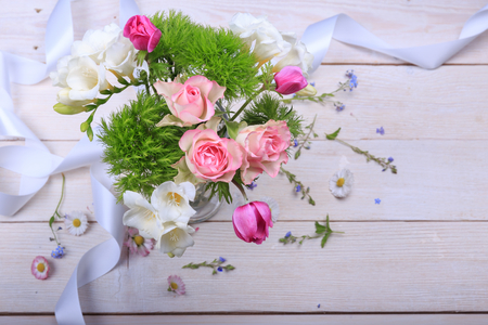 Festive flower composition on the white wooden background. Overhead view.の写真素材