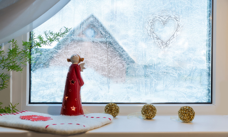 Christmas background, angel on winter window.の写真素材