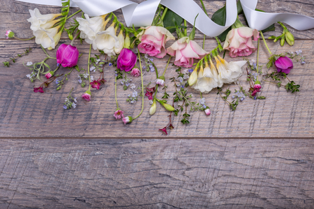 Festive flower composition on the old wooden background. Overhead view.の写真素材