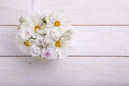 A bouquet of white flowers on white boardsの写真素材