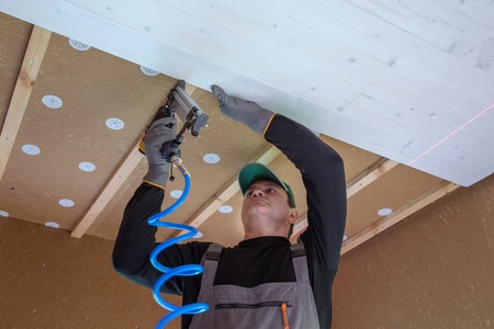 Construction worker thermally insulating eco wooden frame houseの写真素材