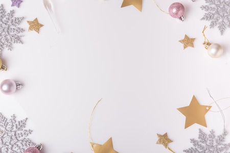 Christmas holiday composition. Festive creative gold silver pattern, xmas pink decor holiday ball with ribbon, snowflakes on white background. Flat lay, top viewの写真素材
