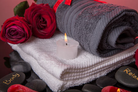 Spa concept in Valentine's Day, red roses, candles in the shape of heart, black therapy stones with the inscription soul, body, relaxの写真素材