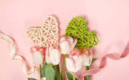 Festive flower pink tulips composition on the light pink background. Overhead top view, flat lay....