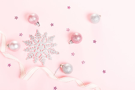 Christmas composition. Xmas pink decor holiday ball with ribbon on white background.の写真素材
