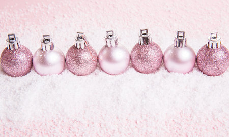Christmas composition. Xmas pink decor holiday ball with ribbon on pink background.の写真素材