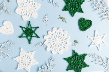 Christmas composition of crocheted white snowflakes and stars on white background. Top view, flat lay, copy space.の写真素材