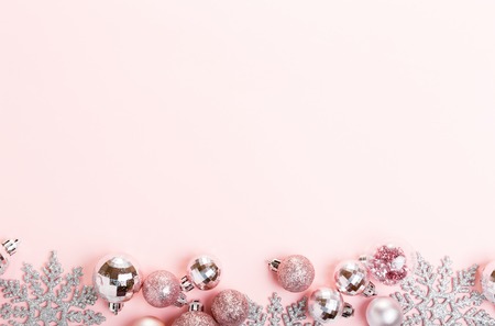 Christmas composition. Xmas pink decor holiday ball with ribbon on pink background.の写真素材