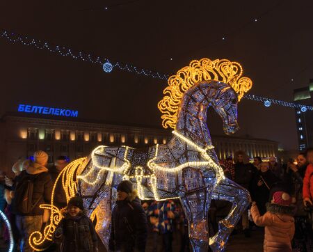 Minsk, Belarus - December 30, 2018: Christmas tree, illuminations and decorations in front of building of the Palace of Republic in Oktyabrskaya Square.のeditorial素材